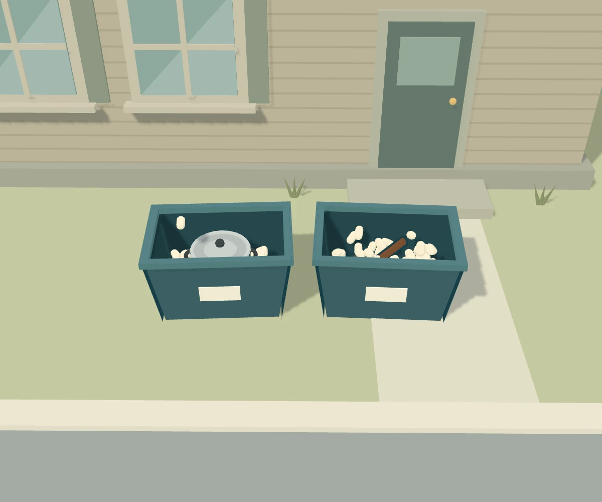 Two moving totes being packed with a stock pot, a frying pan and packing peanuts